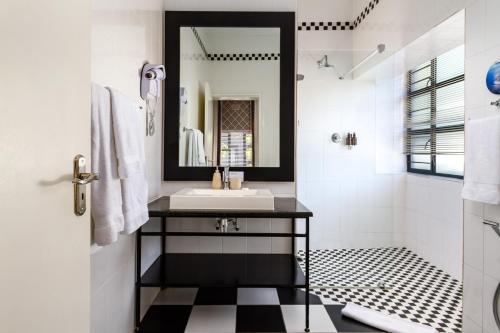 a bathroom with a sink and a mirror at Life & Leisure Boutique Guesthouse in Stellenbosch