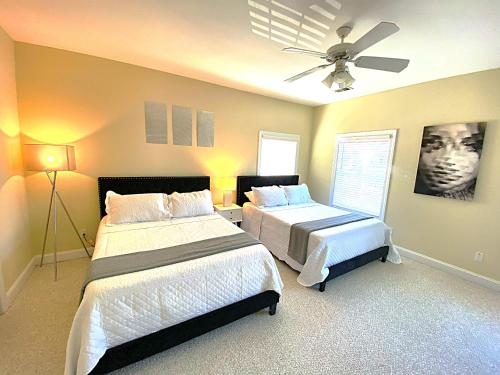 a bedroom with two beds and a ceiling fan at *Stylish* Luxury Suite Near Historic Downtown in Charleston