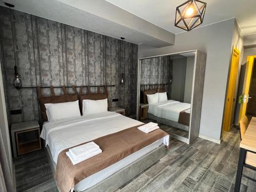 a hotel room with two beds and a mirror at Gudauri Loft Hotel in Gudauri