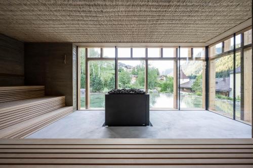 a large room with large windows and a podium at Adler Spa Resort Dolomiti in Ortisei
