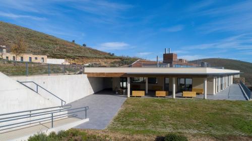a house on the side of a hill at Hotel CampusPHI in Acebo