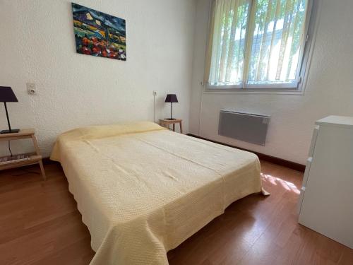 a bedroom with a large bed and a window at La Résidence - n° 02 - T2 classé** in Gréoux-les-Bains