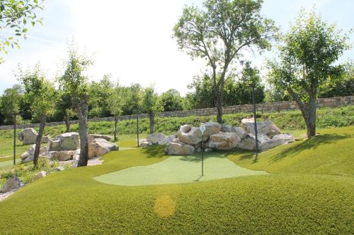 a golf course with rocks and a putting green at Plitvice Village in Korenica