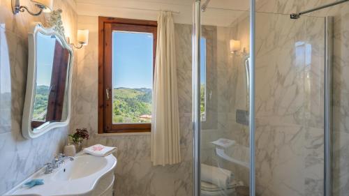 a bathroom with a sink and a glass shower at Villa Dolphin 10, Emma Villas in Massarosa