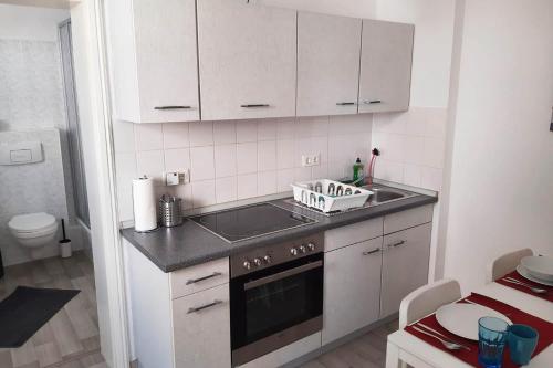a kitchen with a sink and a stove top oven at Cozy 1 room apartment in Magdeburg in Magdeburg