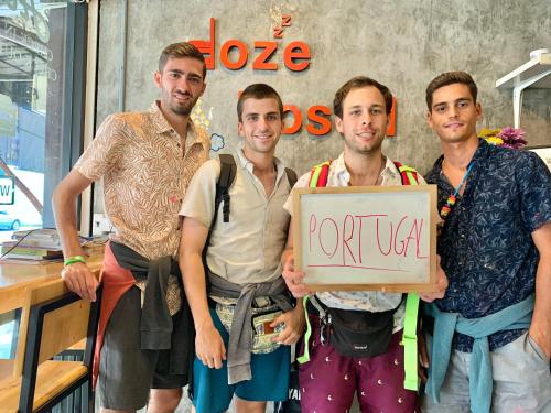 a group of men holding a sign that says rotaria at Doze Hostel in Chiang Mai