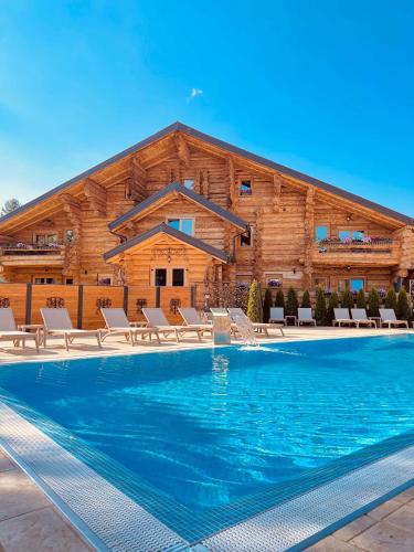 a house with a swimming pool in front of a building at Brvnara Antika in Veliko Gradište