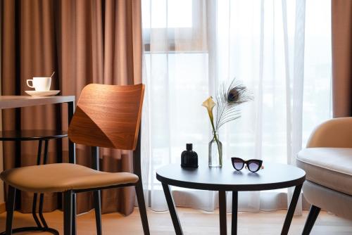 a room with a table and chairs and a window at Mercure Geneva Airport in Geneva