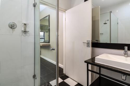 a bathroom with a sink and a shower at Life & Leisure Boutique Guesthouse in Stellenbosch