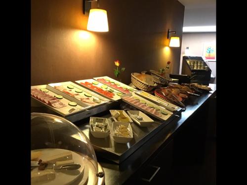 a buffet line with many different types of food at New Hotel Charlemagne in Brussels