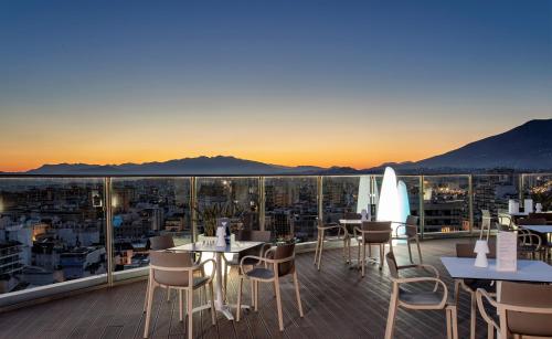 a restaurant with tables and chairs on a balcony at Hotel El Puerto by Pierre Vacances in Fuengirola