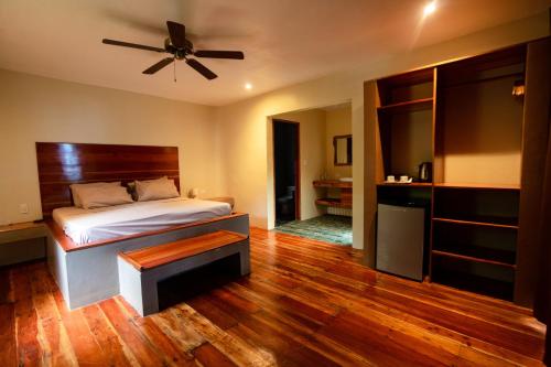 a bedroom with a bed and a ceiling fan at Nakabalo Guesthouse & Restaurant in Siquijor