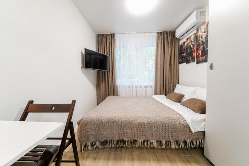 a small bedroom with a bed and a television at Апартаменти MYFREEDOM поруч інститут Шалімова in Kyiv