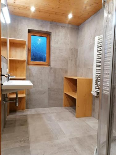 a bathroom with a sink and a window at Landhaus Brixental in Westendorf