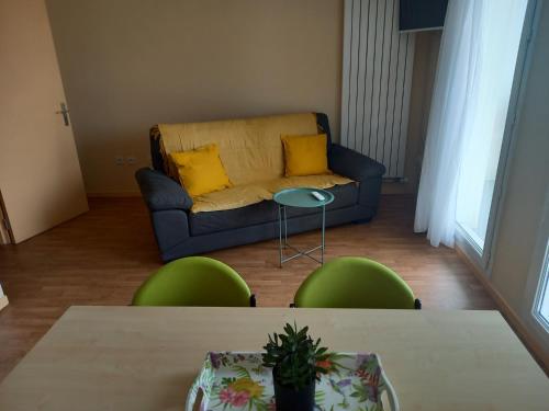 a living room with a couch and a table and chairs at Centre Jean XXIII in Annecy