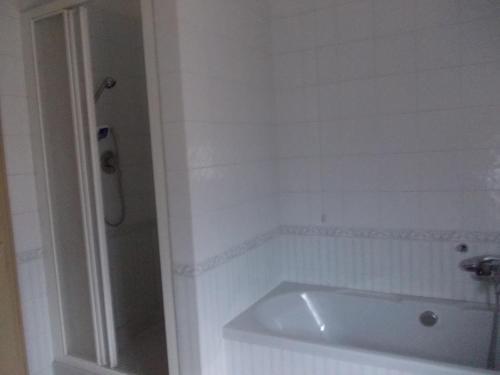 a white bathroom with a tub and a shower at Big Brother Bed & Rooms in Treviso
