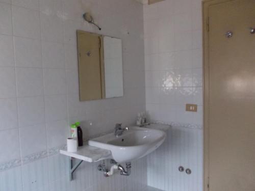 a white bathroom with a sink and a mirror at Big Brother Bed & Rooms in Treviso