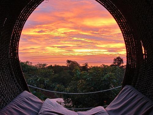 a view of a sunset from a hammock at Nakabalo Guesthouse & Restaurant in Siquijor