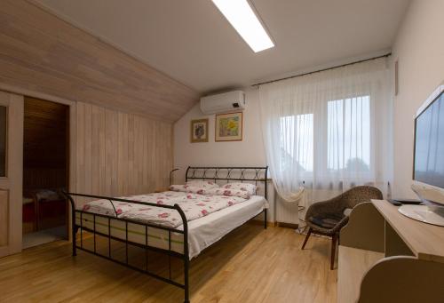 Postel nebo postele na pokoji v ubytování Apartamentai Dana