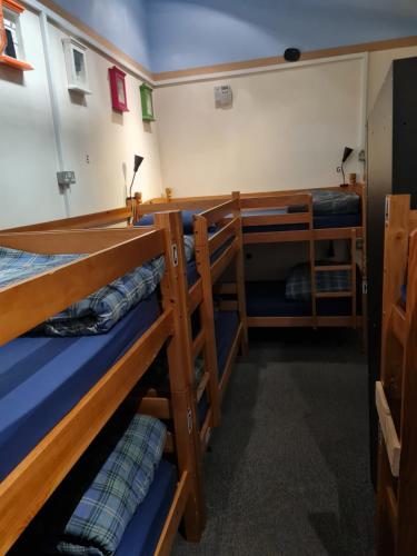 a room with three bunk beds in a boat at Belford Hostel in Edinburgh
