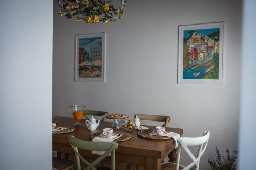 a dining room with a wooden table and chairs at Agriturismo La Terrazza in Velva