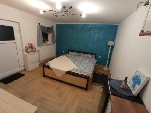 1 dormitorio con cama y pared azul en Freya´s room, en Česká Kamenice