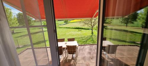a view of a table and chairs from a window at Hotel Rhöner Land Garni - Bed & Breakfast in Oberthulba