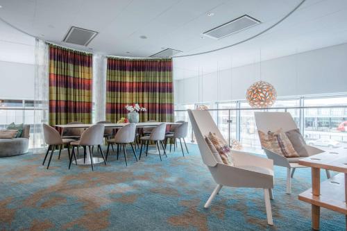 a dining room with a table and chairs at Radisson Blu Hotel Uppsala in Uppsala