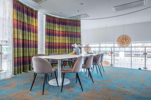 a dining room with a table and chairs at Radisson Blu Hotel Uppsala in Uppsala
