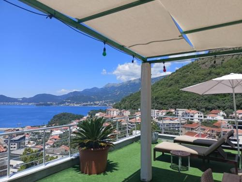 a balcony with a view of the water and mountains at Guest house Villa Slavica in Sveti Stefan