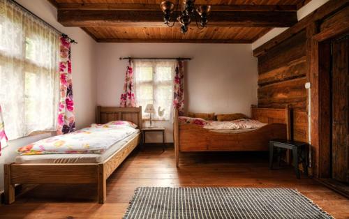 a bedroom with two beds and a window at Kwietne Łąki in Ruciane-Nida