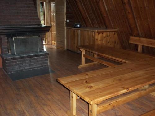 a wooden bench in a room with a fireplace at Silmači in Launkalne
