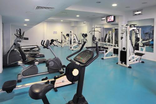 a gym with several treadmills and cardio machines at Nestor Hotel in Ayia Napa