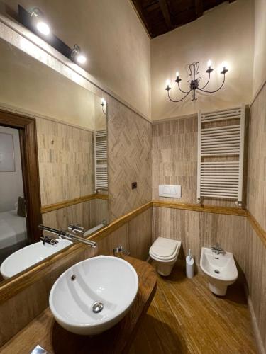 a bathroom with a sink and a toilet and a mirror at Al Palazzetto in Tivoli
