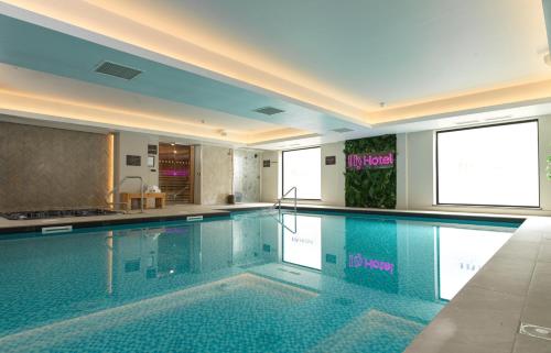 a large swimming pool in a hotel room at Hy Lytham St Anne's in Lytham St Annes