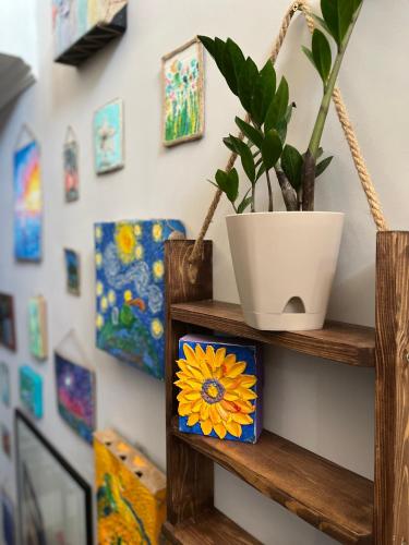 a shelf with a plant and a flower on it at People Hostel in Bishkek