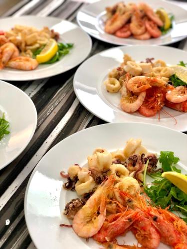 a group of plates of shrimp on a table at La Cartolina del Sannio in Campolattaro