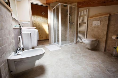 uma casa de banho com um WC, um chuveiro e um lavatório. em La Marmote Albergo Diffuso di Paluzza San Nicolò em Paluzza