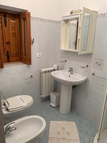uma casa de banho com um lavatório e um WC em Agriturismo Galletta em Leni