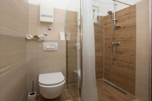 a bathroom with a toilet and a shower at Situs Katarina in Trogir