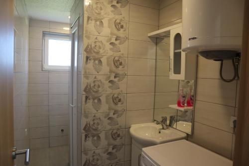 a small bathroom with a toilet and a sink at Lotus Villas in Travnik