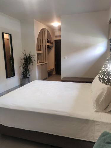 a large white bed in a room with at Asimina Suites in Nikiti