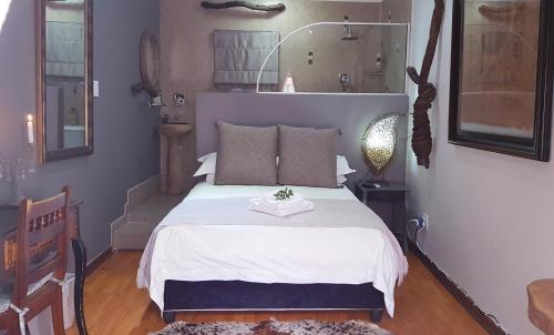 a bedroom with a bed with a white bedspread at Lamon Guesthouse in Kroonstad