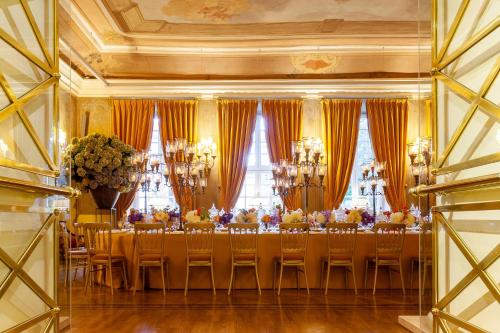 a dining room with a long table with chairs at NARUTIS Hotel - Small Luxury Hotels of The World in Vilnius