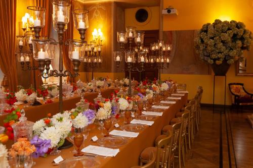 a long dining room with long tables and chairs at NARUTIS Hotel - Small Luxury Hotels of The World in Vilnius