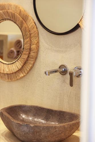a bathroom with a wooden sink and a mirror at Life Suites in Tourlos