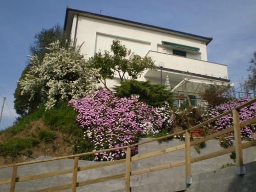 a house with pink flowers in front of it at La Casina di sopra AAUT in Sestri Levante