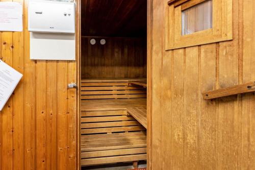 an empty sauna with a wooden door in a room at Ferienwohnung Fetscher 2 in Reichenau