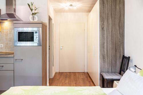 a small room with a bed and a kitchen at Ferienwohnung Fetscher 1 in Reichenau