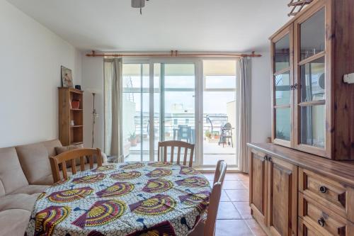 a living room with a table and a couch at Sea view apartment in St Paul's Bay in St. Paul's Bay